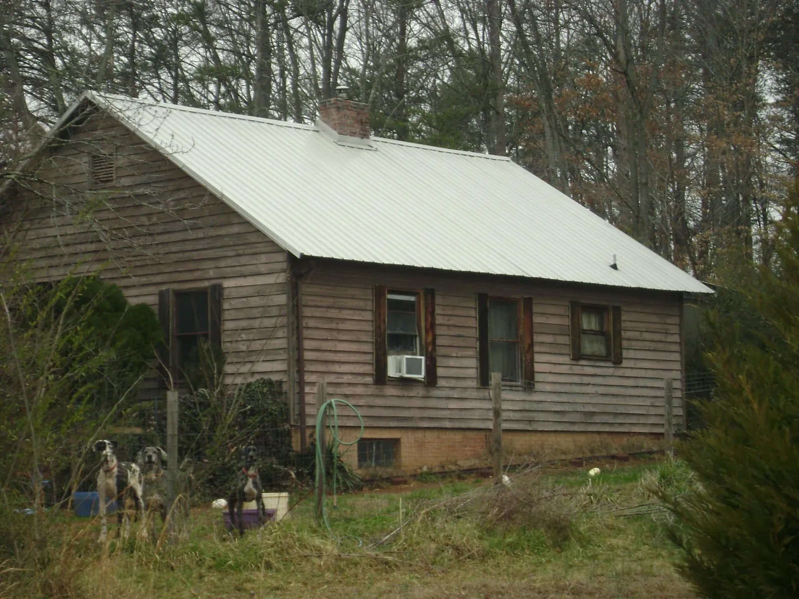 White metal roof on an old wood sided farmhouse, from a Metal Roof Installation job in Berkey